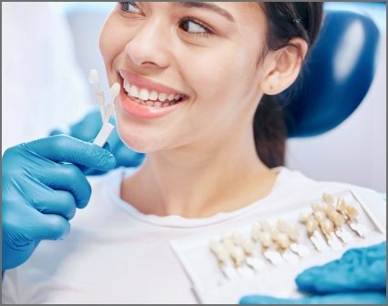 Dentist treating patient and patient is smiling
